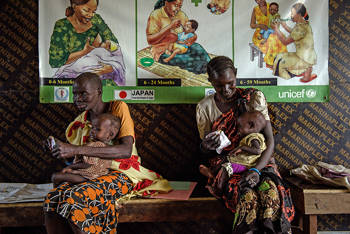 Two women holding their baby in their arms